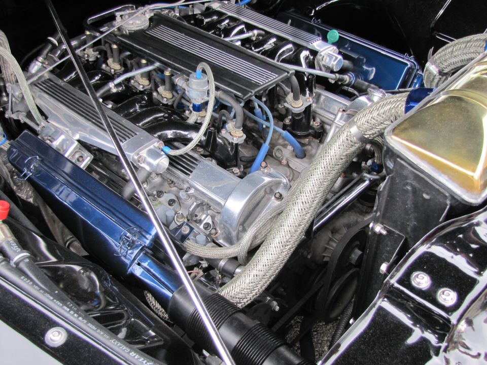 Engine bay with chrome and blue accents, braided hoses