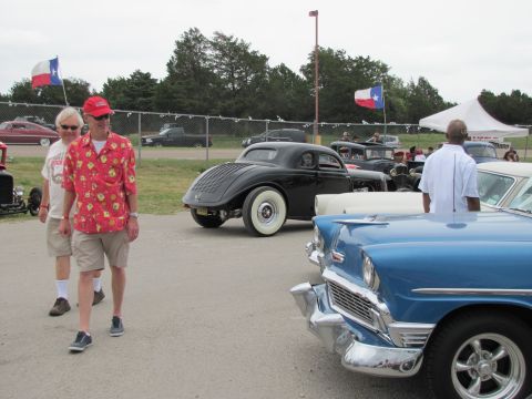2006 BMW 5 Series - Classic cars and hot rods gathered at an outdoor event under a cloudy sky.