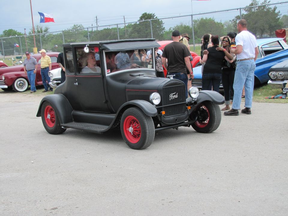 Black Ford Model T coupe with red wheels and a matte finish