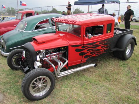 2006 BMW 5 Series - Custom hot rod pickup truck with flame decals and a powerful V8 engine on display.