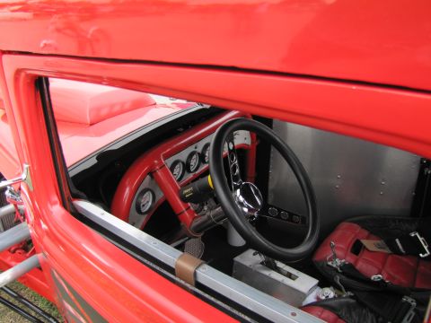 2006 BMW 5 Series - The interior of a custom hot rod features a steering wheel, dashboard gauges, and a racing seat.