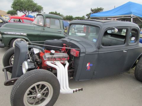 2006 BMW 5 Series - Custom hot rod coupe parked next to a vintage Chevrolet truck at an outdoor event.