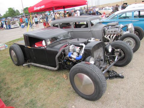 2006 BMW 5 Series - Custom hot rod with exposed engine and turbo, seen at an outdoor car show.