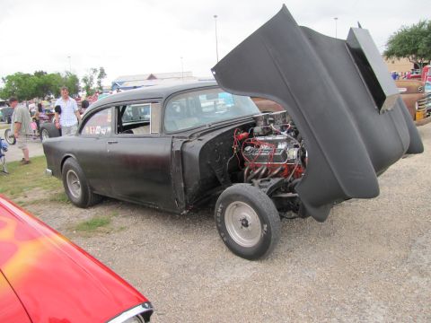 2006 BMW 5 Series - A modified 1955 Chevrolet hot rod is displayed with its hood open, revealing a powerful V8 engine.