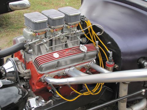 2006 BMW 5 Series - Close-up of a custom engine Edelbrock valve covers and a triple carburetor setup.