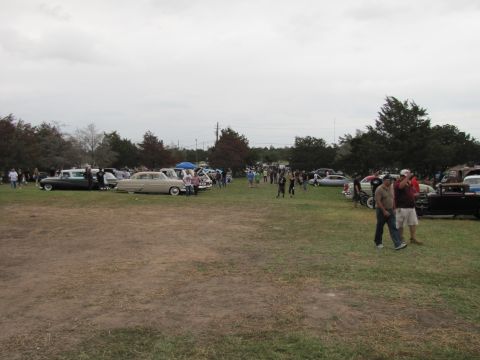 2006 BMW 5 Series - A gathering of vintage automobiles on display under an overcast sky.