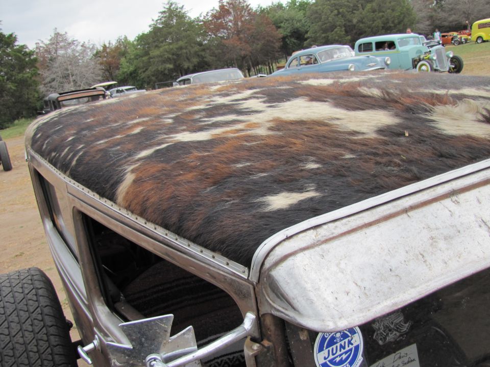 Custom hot rod with cowhide roof and visible tire