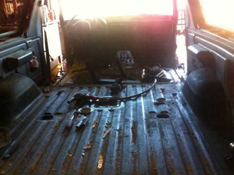 1989 Ford Bronco - The interior of a 1989 Ford Bronco is shown with the seats removed and the floor stripped.