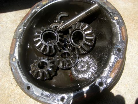 1996 Ford Bronco - Differential gears and housing showing significant wear and metal shavings, indicating potential mechanical failure.