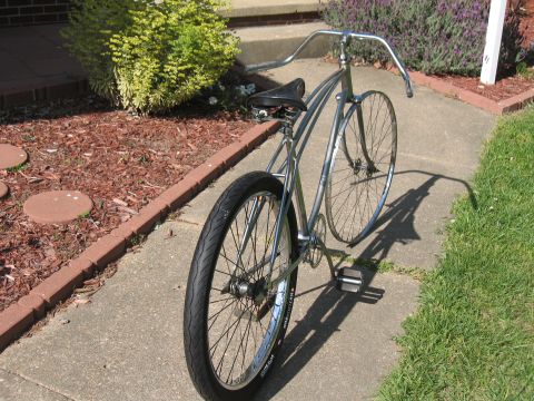 1994 Ford Bronco - A vintage-style bicycle with chrome frame and black seat sits on a concrete path.