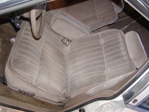 1991 Ford LTD Crown Victoria - The interior of a car features velour bench seats and a steering wheel.