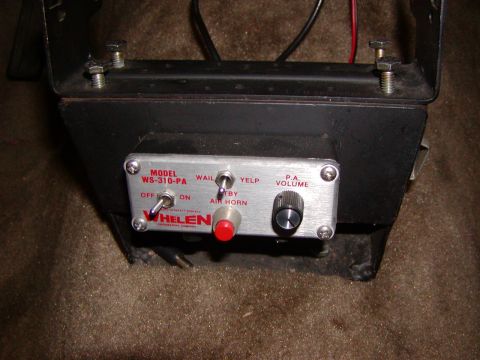 1991 Ford LTD Crown Victoria - A Whelen WS-310-PA siren control unit is shown, various function switches and a volume knob.