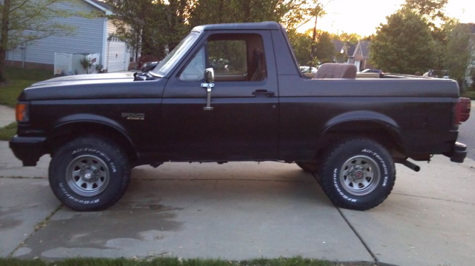 1987 Ford Bronco parked on driveway, side view
