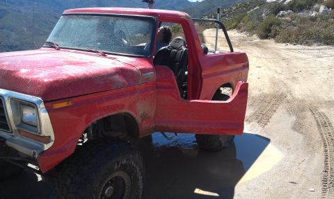 1978 Ford Bronco - This red pickup truck appears to be a 1979 model, modified for off-road use.