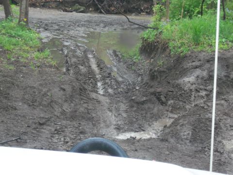 1989 Ford Bronco - The vehicle navigated a challenging muddy path with deep ruts and water obstacles.