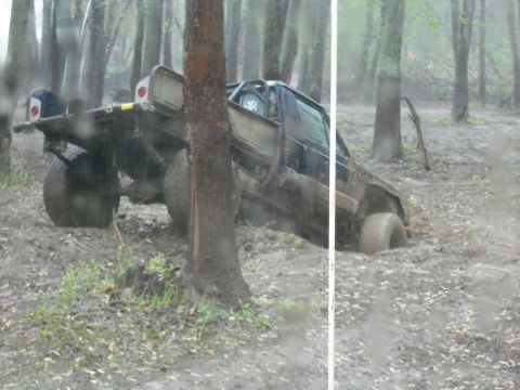 1989 Ford Bronco - This off-road vehicle appears to be stuck in the mud while navigating a wooded area.