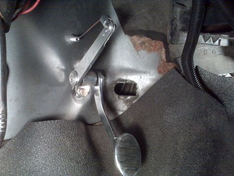 1978 Ford Bronco - The accelerator pedal mechanism and surrounding floor pan show signs of wear and rust.