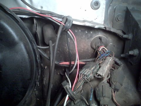 1978 Ford Bronco - Close-up of a vehicle's engine bay wiring, showing a complex and somewhat disorganized harness.