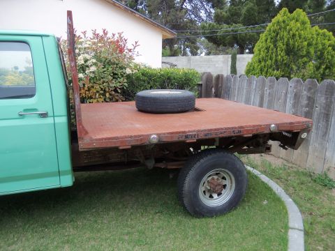 1968 Ford Bronco - This flatbed truck appears to be from the 1990s, not a 1968 Ford Bronco.