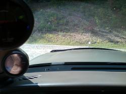 2000 Mercury Grand Marquis - Interior view from the driver's seat, focusing on dashboard gauges and the road ahead.