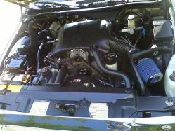 2000 Mercury Grand Marquis - The engine bay of a 2000 Mercury Grand Marquis is shown, a V8 engine and an aftermarket air intake system.