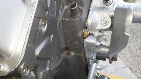 1978 Ford Bronco - Close-up view of an engine block with a sensor attached, indicating a motor rebuild.