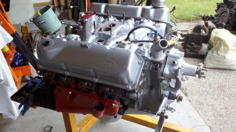 1978 Ford Bronco - A silver Ford V8 engine is mounted on an orange engine stand, ready for installation or rebuild.