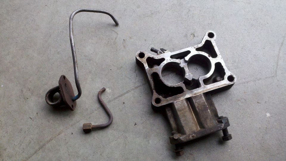 Fuel line and carburetor base plate on concrete