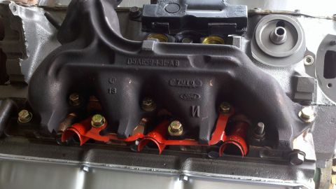 1978 Ford Bronco - Close-up of an engine manifold with visible part numbers and manufacturer markings.