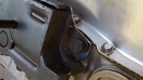 1978 Ford Bronco - Engine mounting bracket assembly showing bolts and threaded rod detail.