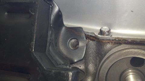 1978 Ford Bronco - Detail of an engine part, possibly related to a motor rebuild, with visible hardware and gasket material.