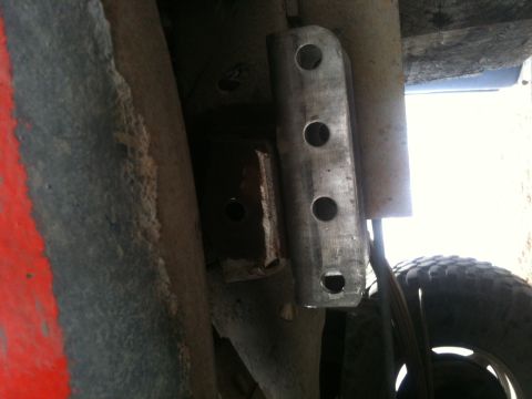 1990 Chevrolet Suburban - A close-up view of a vehicle's undercarriage reveals a custom-mounted metal bracket attached to the frame.