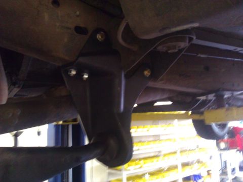 1992 Ford F-150 - Close-up view of a vehicle's underbody suspension bracket, showing bolted components.