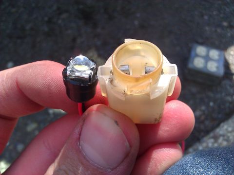 1992 Ford F-150 - Close-up of an LED bulb and its corresponding socket.