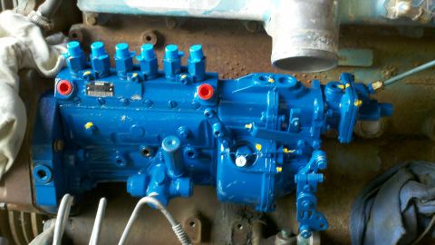 1993 Ford F-350 - A bright blue fuel injection pump is shown, likely part of an engine swap. Text is visible on a small identification plate.
