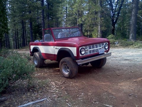 1968 Ford Bronco - This 1968 Ford Bronco is parked on a dirt road surrounded by trees.
