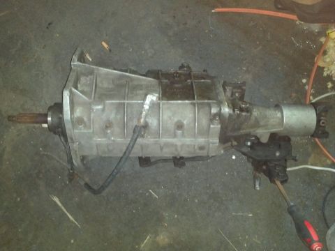 1966 Ford Fairlane - An automatic transmission part is shown on a dark floor with some debris.