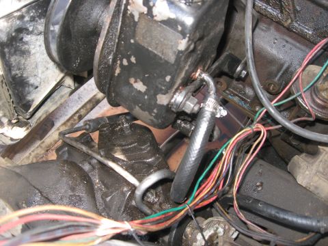 1981 Ford Bronco - This image shows a close-up view of various engine components, including hoses and wiring, within a vehicle's engine bay.