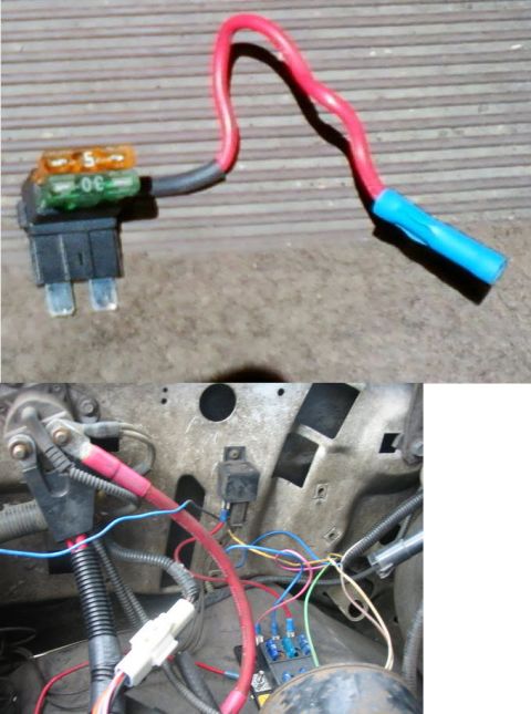 1992 Ford Bronco - A close-up view of a vehicle's fuse block and wiring harness, showing multiple fuses and connections.