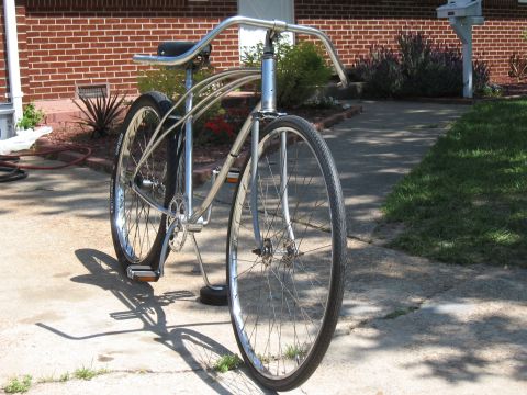 1994 Ford Bronco - Custom cruiser bicycle parked on a concrete driveway in front of a brick house.