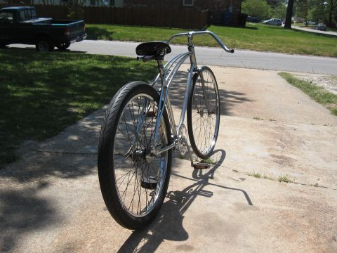 1994 Ford Bronco - A shiny cruiser bicycle sits on a driveway, casting a long shadow in the sunlight.