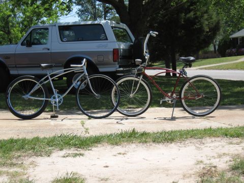 1994 Ford Bronco - A silver 1994 Ford Bronco is parked behind two cruiser bicycles, one silver and one red.
