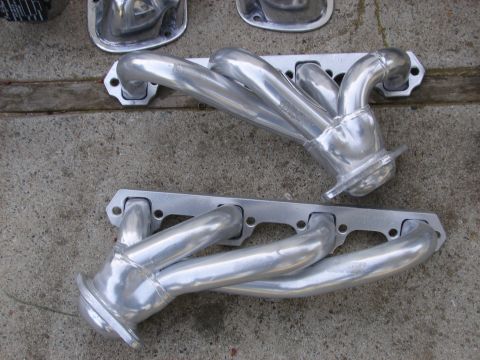 1973 Ford Ranchero - Polished aluminum exhaust headers are shown laid out on a concrete surface.