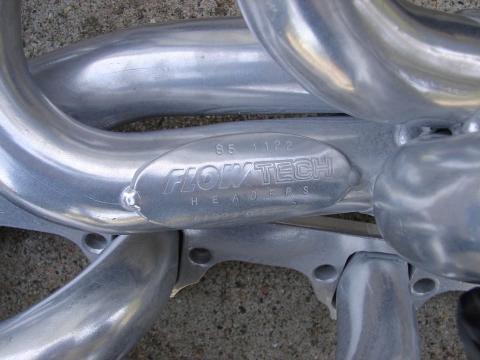 Flowtech headers with part number 85 1122 stamped on a metal tag