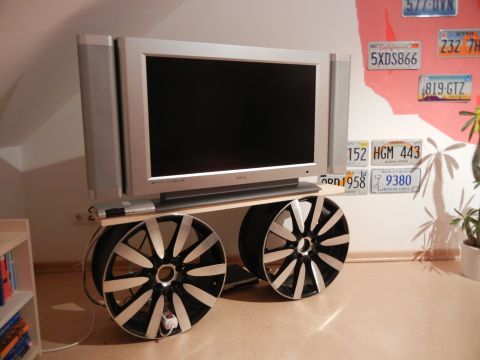 2003 Audi A6 - A television is repurposed as a mobile unit, supported by two alloy wheels.