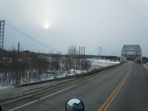 2009 Kenworth T800 - View from a truck cab driving towards a bridge on a winter day, with a reflection of the truck in the side mirror.