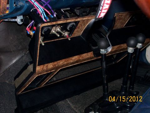1982 Ford F-100 - Aftermarket switches and shifters are installed in the vehicle's center console area.