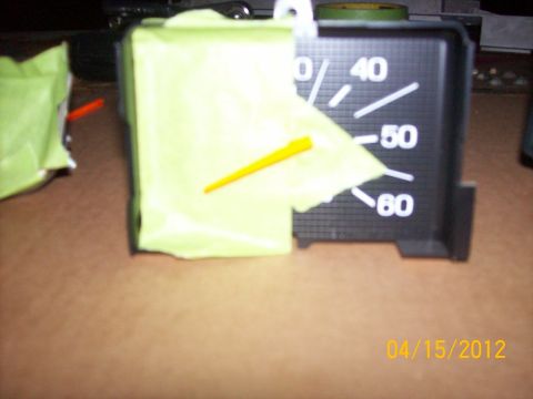1982 Ford F-100 - A gauge cluster is partially covered with tape, with a yellow needle visible.