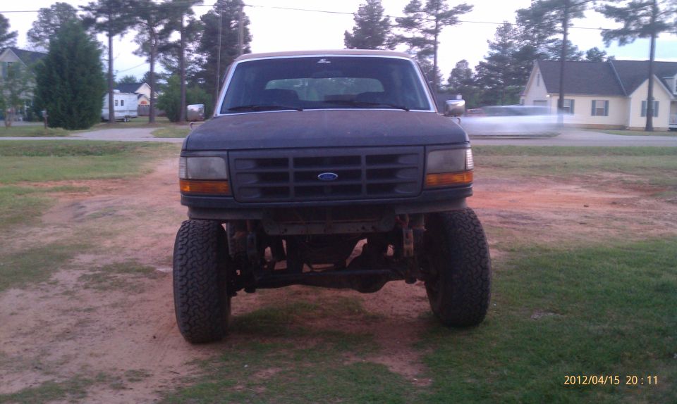 Front view of a lifted Ford Bronco with a dark grille and large tires