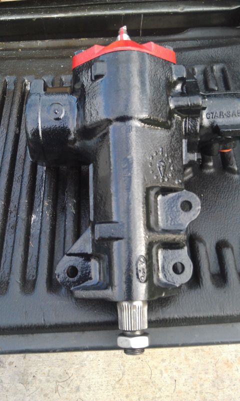 1978 Ford Bronco - A black steering gear box with red accents is shown, resting on a textured surface.
